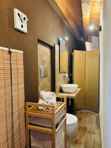 a bathroom with a toilet and a sink at Spera Luxury Palermo & SPA in Palermo