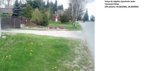 a walkway in a yard with grass and flowers at Apartmán Jarka in Tatranska Strba