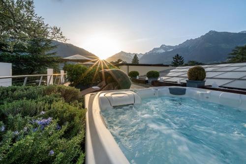 a hot tub on the roof of a house at Hotel Mignon Meran Park & Spa in Merano