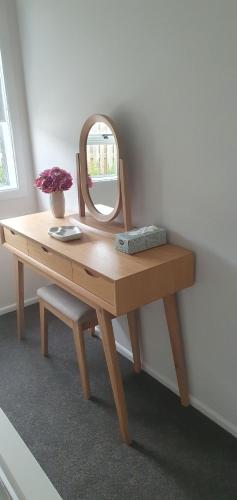 a dressing table with a mirror on top of it at Arbor Suite in Greytown