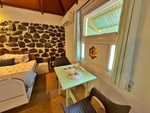 a small room with a table and a window at Captans Stay in Lonavala