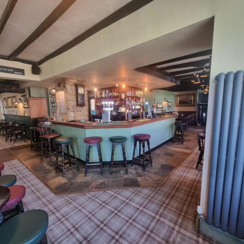 a bar in a restaurant with bar stools at The Mcorville Inn in Elwick