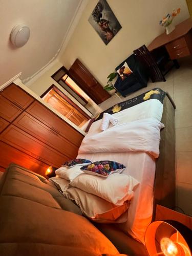 a bedroom with two beds with pillows at Kamona Living 3 Zimmer Apartment in Namugongo