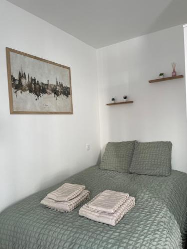 une chambre avec un lit avec deux serviettes dessus dans l'établissement Le cocon de la chouette, à Dijon