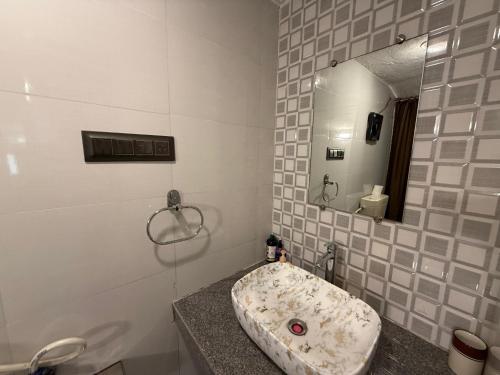 a bathroom with a sink and a mirror at Captans Stay in Lonavala