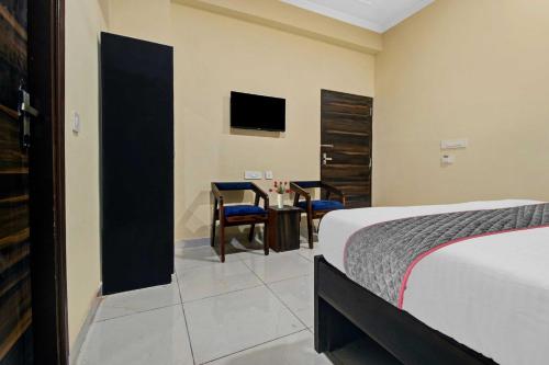 a bedroom with a bed and a table and a tv at Collection O Aloft in Jaipur
