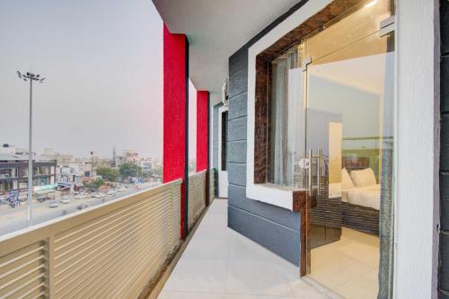 a balcony with a bed and a view of a city at Collection O Aloft in Jaipur