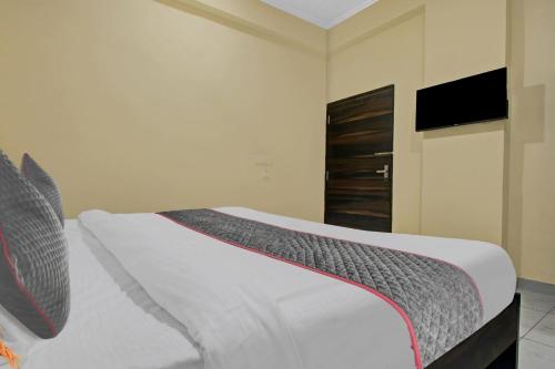 a bedroom with a bed with a television on the wall at Collection O Aloft in Jaipur