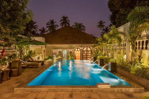 a swimming pool in front of a house at LostTraveller 3BHK Villa with a view Private Pool in Saligao LT347 in Saligao