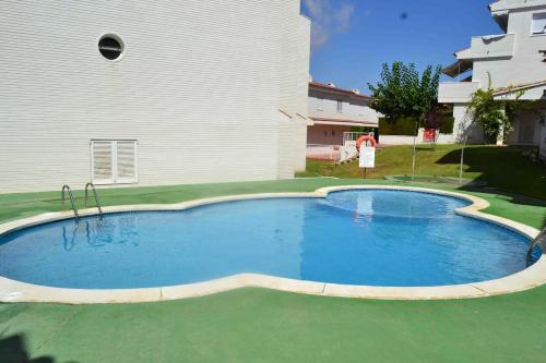 a large swimming pool in front of a house at Beach house with pool at the Fortí viewpoint in Altafulla