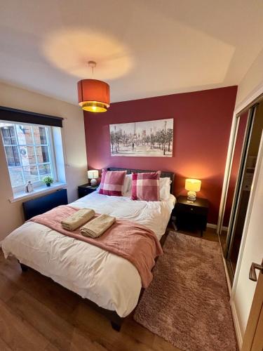 a bedroom with a large bed with two pillows at The Wheel House - Private Front door and Free Parking in Edinburgh