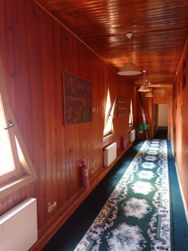 an empty hallway with wood paneling and a rug at Zakarpatska Kolyba in Odesa
