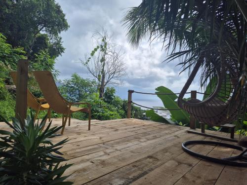 a wooden deck with two chairs and a hammock at Calm Sorento in Glacis