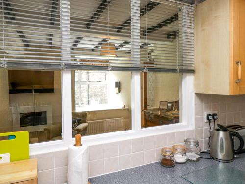 a kitchen with a large window in a kitchen at Fox Barn in Kendal