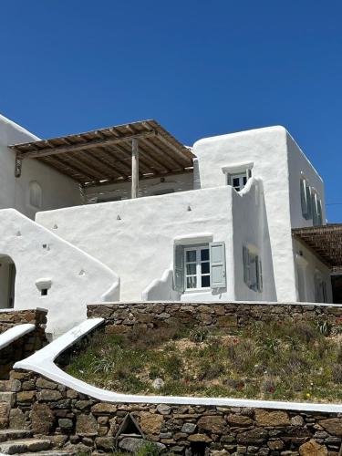 a white building with a window on the side of it at Blue and White Mykonos ap2 in Mikonos