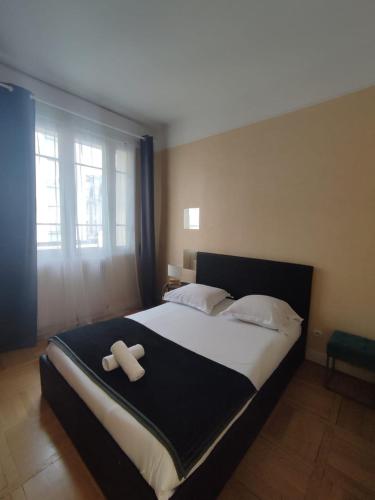 - une chambre avec un grand lit et 2 oreillers blancs dans l'établissement La cour d'école à Tours, à Tours