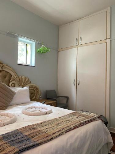 a bedroom with a large bed with two pillows on it at Wonderful Guest house in Durban