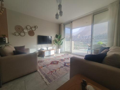 a living room with a large window and a television at IL MONTE Galala -families only- المونت جلالة in Ain Sokhna