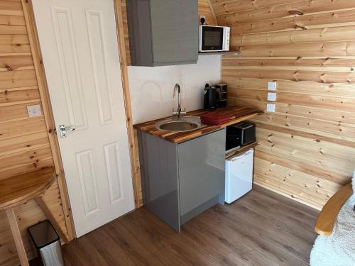 a kitchen with a sink in a tiny house at Oakwood Farm Chester in Chester