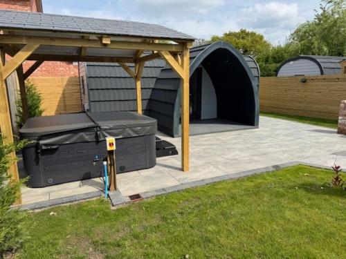 a backyard with a grill and a gazebo at Oakwood Farm Chester in Chester