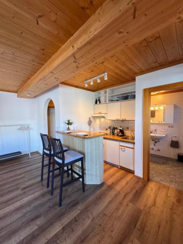 a kitchen with a table and chairs in a room at City-apart Kitzbühel Stadt in Kitzbühel