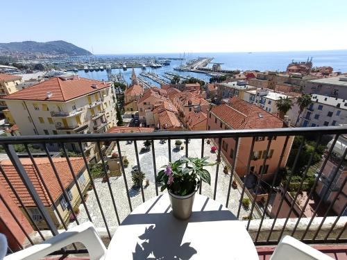 a balcony with a table and a view of a harbor at Hotel Robinia in Imperia