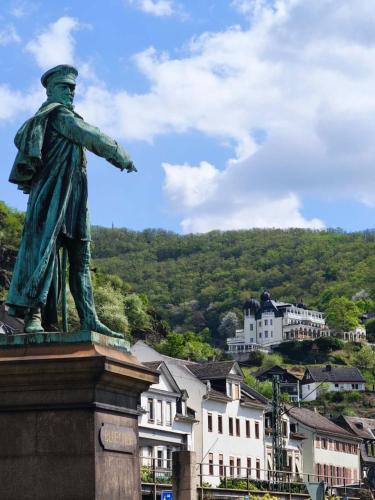 a statue of a man standing in front of a town at Goldner Stern Kaub in Kaub