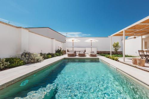 a swimming pool in the backyard of a house at Frantoio Luxury Villa by HDSalento in Melendugno