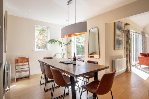 a dining room with a wooden table and chairs at Large home to sleep 8 in Kenmare. Free use of pool onsite in Kenmare