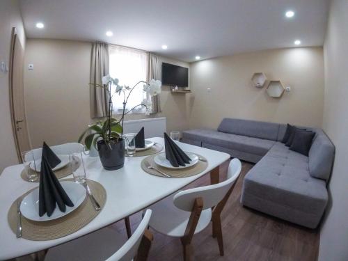a living room with a table and a couch at Guest Rooms Lencho in Anton
