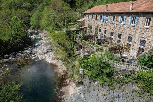 an aerial view of a river next to a building at Rives de Bourges in Burzet