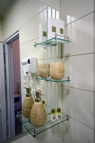a bathroom with three baskets on a glass shelf at Hotel Terrace Rabath in Akhaltsikhe