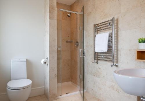 a bathroom with a shower and a toilet and a sink at Large home to sleep 8 in Kenmare. Free use of pool onsite in Kenmare