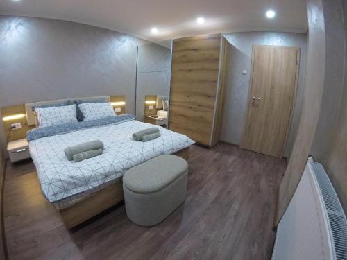 a bedroom with a bed and a stool in it at Guest Rooms Lencho in Anton
