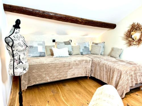 a bedroom with a bed with blue and white pillows at Hotel Particulier Les Rêveries du CLOS derrière St Jean Vignes &Spa Adult Only in Pommard