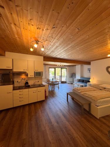 a large room with a bed and a kitchen at City-apart Kitzbühel Stadt in Kitzbühel