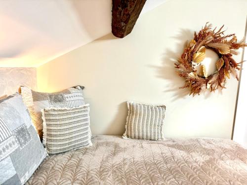 a bedroom with a bed and a wreath on the wall at Hotel Particulier Les Rêveries du CLOS derrière St Jean Vignes &Spa Adult Only in Pommard