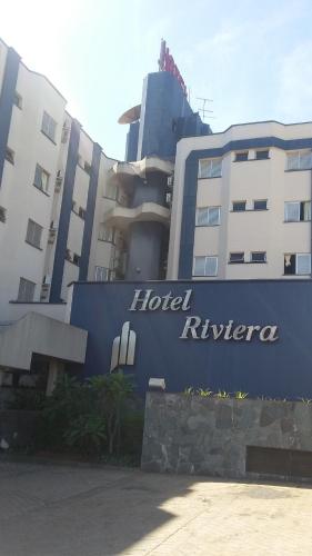 a hotel insurer sign in front of a building at Hotel Riviera in Araçatuba