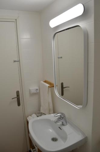a bathroom with a white sink and a mirror at Apartamento en la playa de Empuriabrava in Empuriabrava