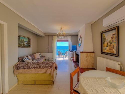 a living room with a bed and a couch at Poseidon's Balcony by Infinity in Nea Kalikratia