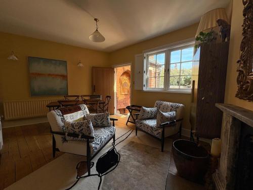 a living room with a couch and chairs and a table at Cosy Cottage in Melbourne in Melbourne