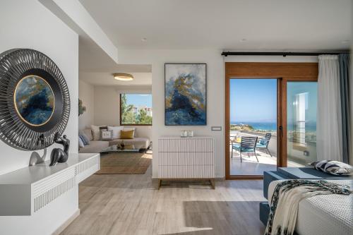 a bedroom with a bed and a living room at Eunoia Blue Villa Heraklion Crete, Sea View, Private Pool, Prassas, Karteros in Prasás