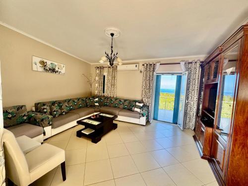 a living room with a couch and a table at Markulata in Khalikerí