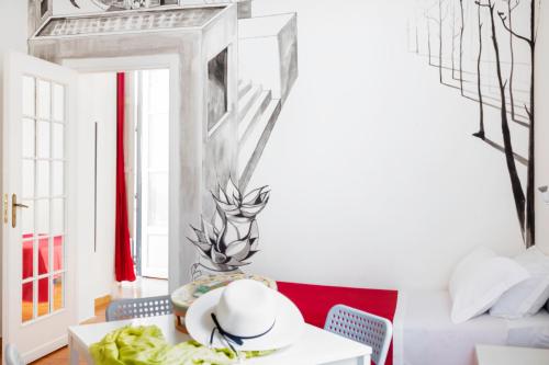 a dining room with a red and white table and chairs at A Casa di Amici in Palermo