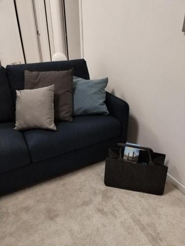 a black couch with pillows and a box in a room at un balcone sul lago in Omegna
