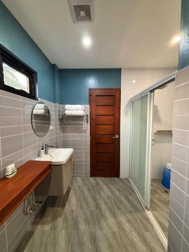 a bathroom with a sink and a mirror at JCPM Apartment Suite-3rd Floor in Santa Cruz
