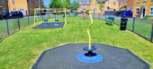 a playground with a yellow rope in a park at Your 4 Bedroom Townhouse - Superking Bed in Stamford