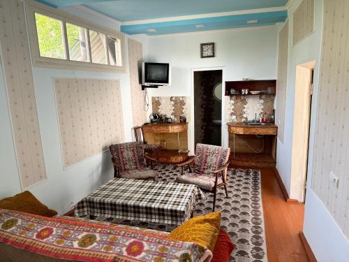 a living room with a couch and a table at Hayq Guest House in Goris