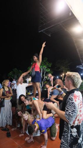 a crowd of people watching a woman jumping in the air at Central Backpackers Hostel - Phong Nha in Phong Nha