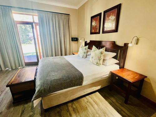 a bedroom with a large bed and a window at 17 on Bird Guest House in Beaufort West